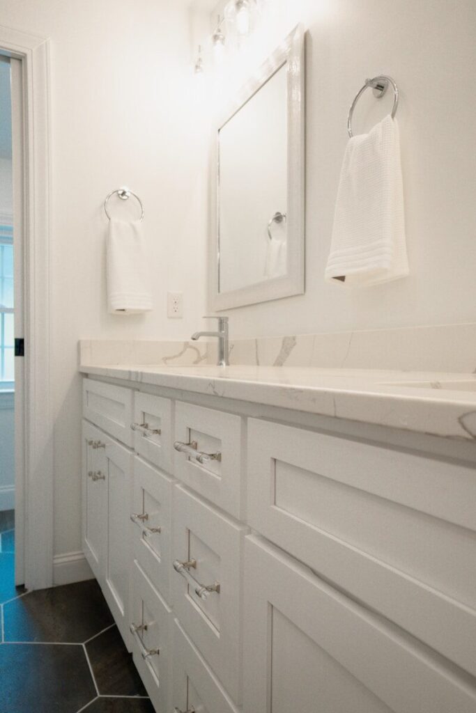 A bathroom with a double sink and a large mirror